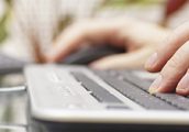 Man is typing on keyboard and using mouse