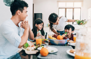 A family sitting around the table eating breakfast.